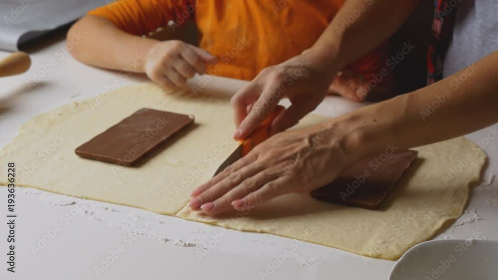 Mother helping son making delicious chocolate cookies Mother helping son making delicious chocolate cookies