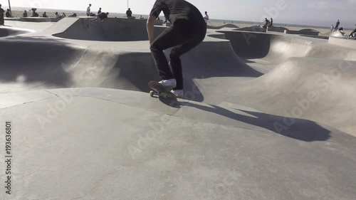Teenage boy skates in skate park