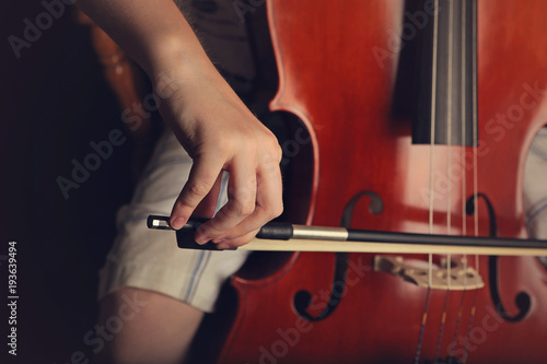 Close up of hands playing a cello
