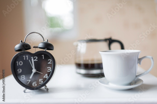 Alarm clock near the bed at home.Morning time background concept
