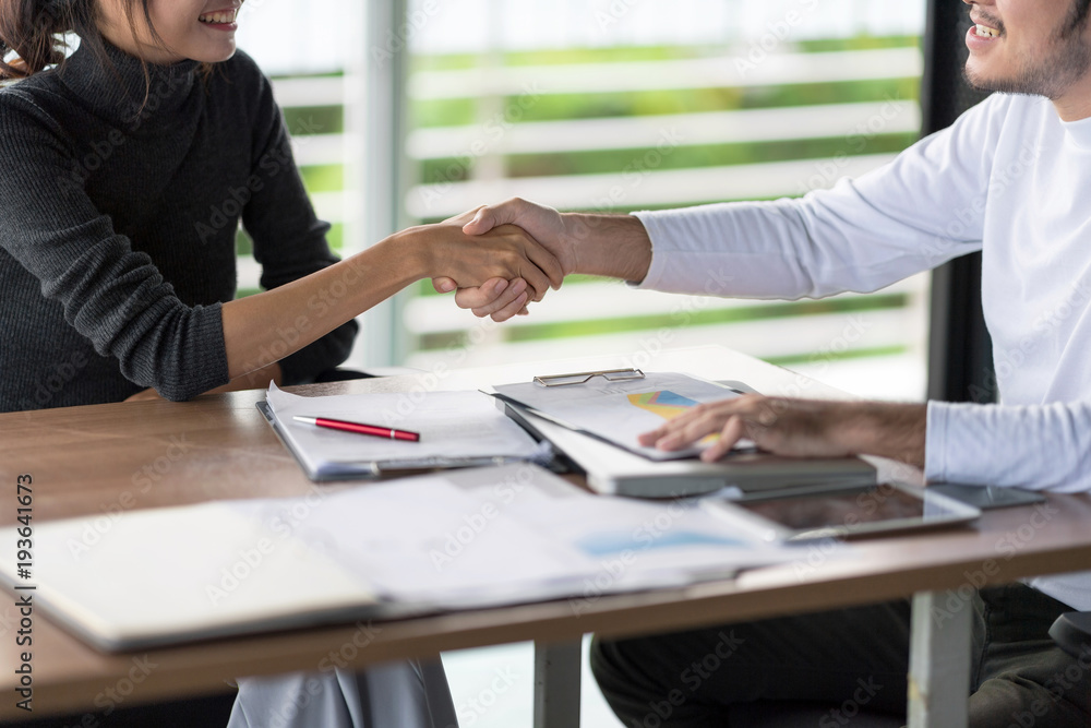 Confident business people are shaking hands after agreeing to a successful job. Set studio shooting Confident business people are shaking hands after agreeing to a successful job. Set studio shooting