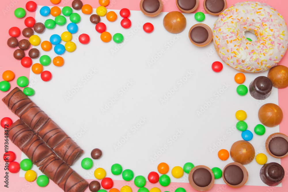 Background of sweets, with a white sheet for inscription. Sweets, sweets, chocolate on a pink background. sweet background.