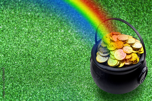Vászonkép Saint Patrick's Day and Leprechaun's pot of gold coins concept with a rainbow indicating where the leprechaun hid treasure on green with copy space