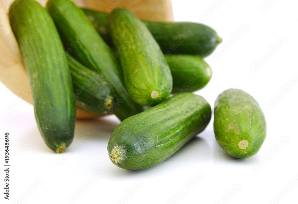 fresh cucumbers in wooden bowl on white fresh cucumbers in wooden bowl on white
