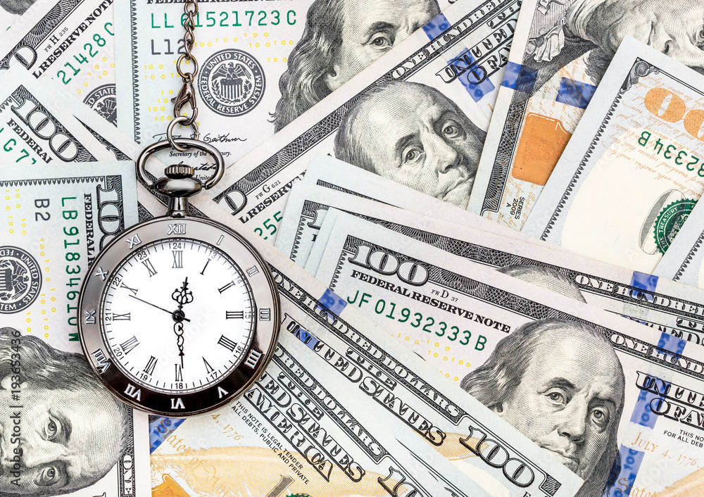 Pocket watch on the background of dollar bills. Pocket watch on the background of dollar bills.