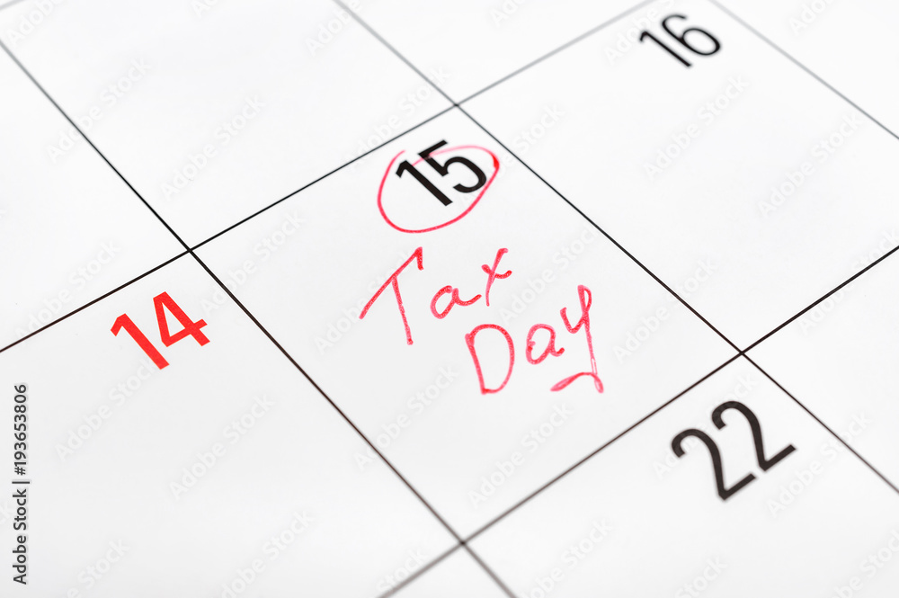 Tax day written on the calendar and circled 15th day by marker. Tax pay Deadline concept. Tax day written on the calendar and circled 15th day by marker. Tax pay Deadline concept.
