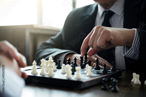 Confident businessman colleagues playing chess game overcome the fear of confrontation to development analysis new strategy plan, leader and teamwork concept for success