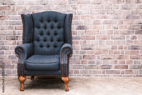 Modern armchair furniture with brick wall in room interior