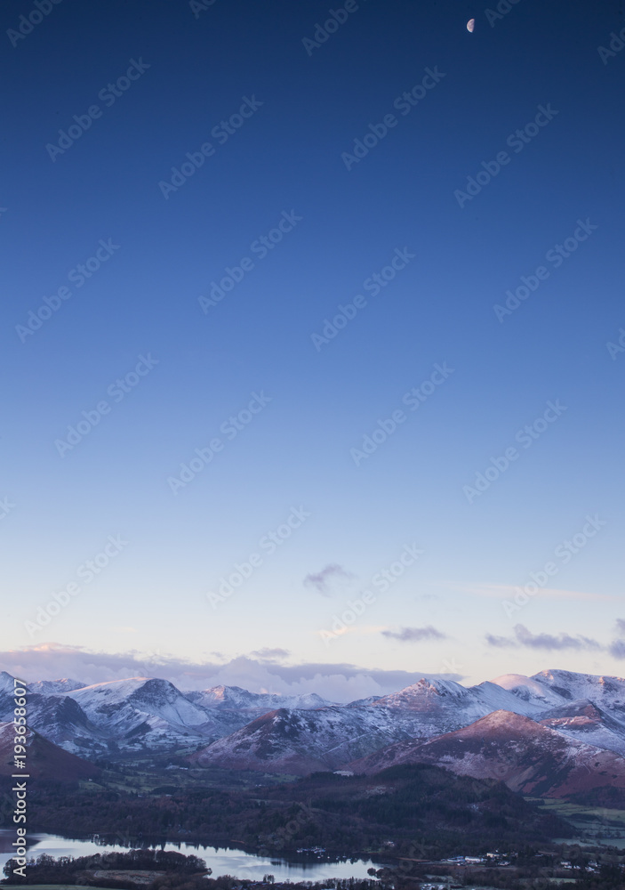 early morning snowy mountains with moon in the sky early morning snowy mountains with moon in the sky
