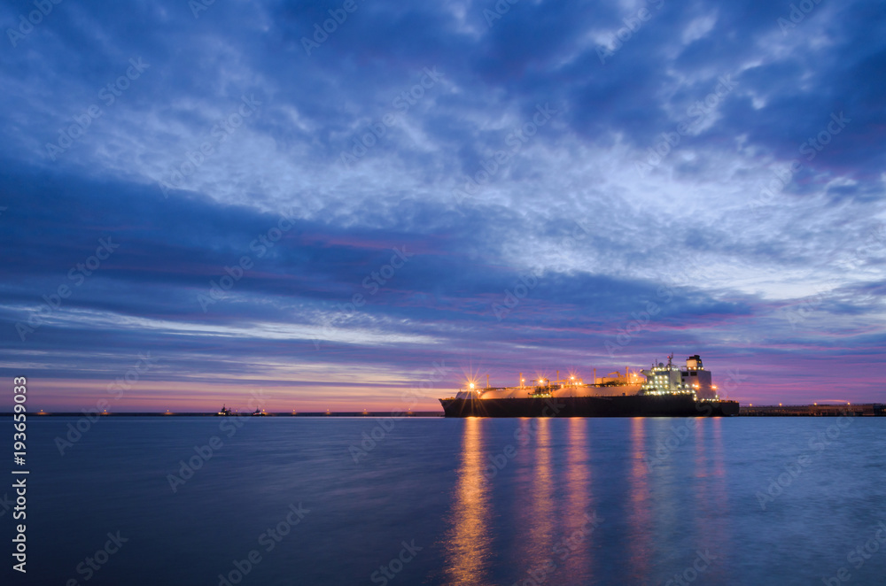 LNG TANKER AT THE GAS TERMINAL - Sunrise over the ship and port