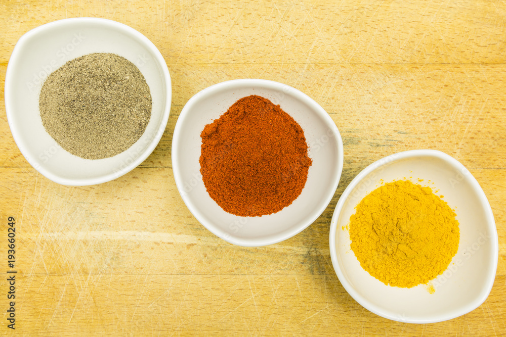 Board with colorful spices in bowls. View from above. Board with colorful spices in bowls. View from above.