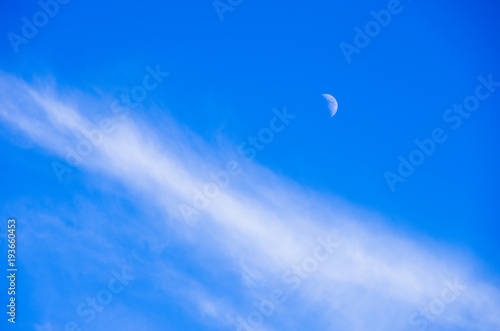 Moon and cloud amid the blue sky