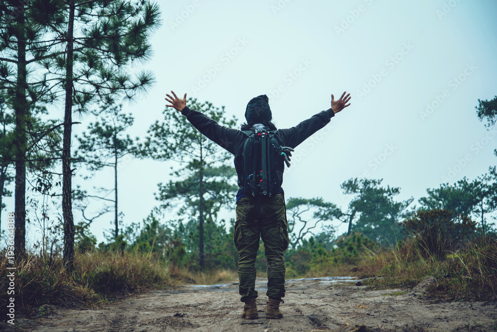 Asian men travel photograph nature. Travel relax. Walk on the path. Nature Study in the Jungle. Thailand Asian men travel photograph nature. Travel relax. Walk on the path. Nature Study in the Jungle. Thailand