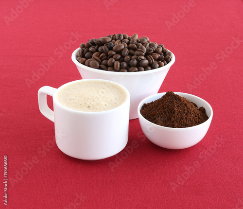 Coffee made with freshly ground coffee powder. In the background are coffee beans in a bowl.