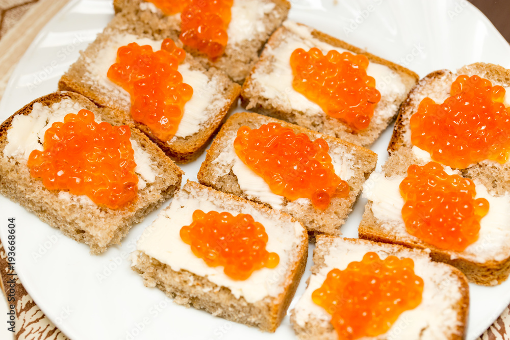 Dishes from sliced bread and red caviar