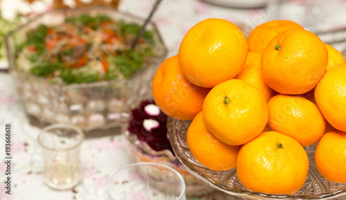 Tangerines in a dish on a table