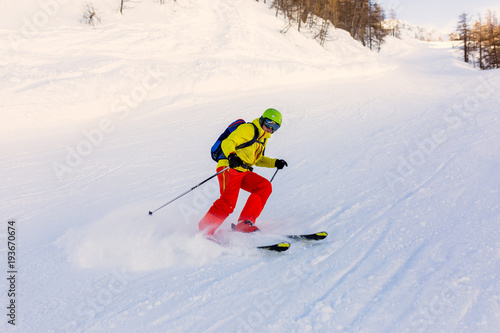 Image of sports man skiing on snowy slope