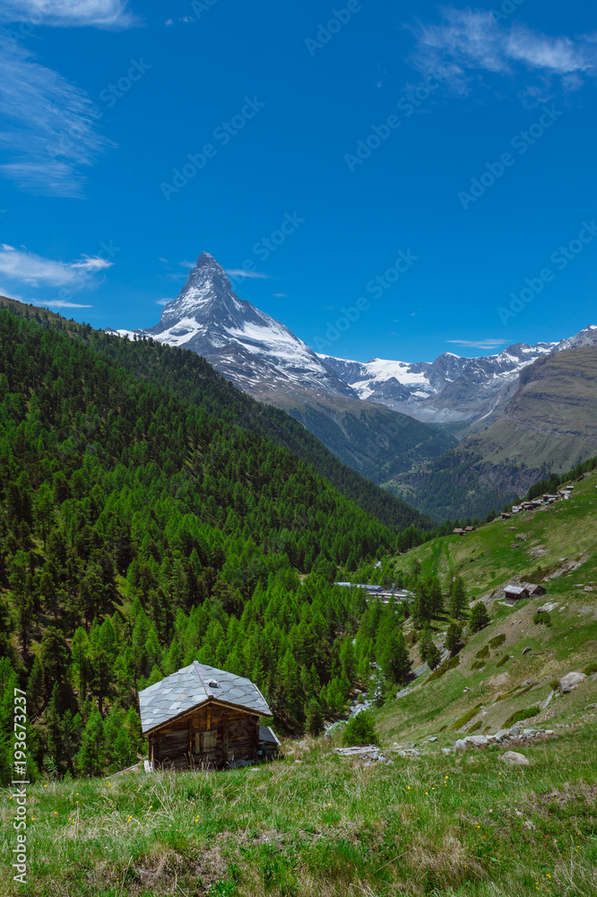 A mountain hut with a view of Matterhorn on a hiking trail in Zermatt, Switzerland A mountain hut with a view of Matterhorn on a hiking trail in Zermatt, Switzerland