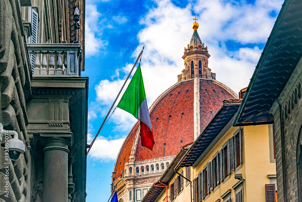flag of Italy on the background of the dome of the Cathedral in Florence