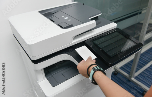Business woman hand is using smart card with printer to printing document