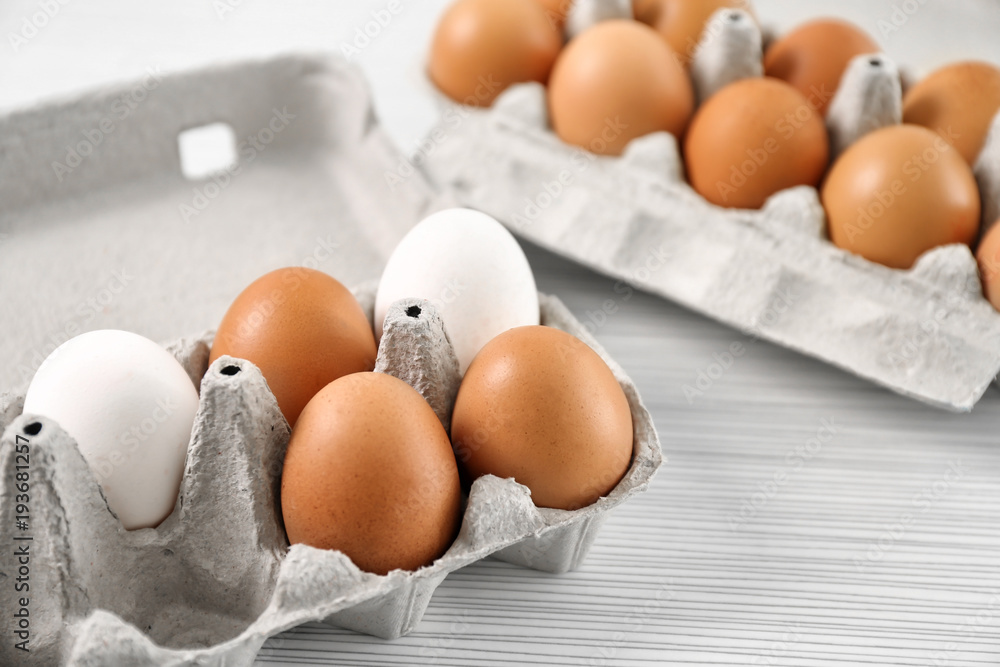 Packages with chicken eggs on table Packages with chicken eggs on table