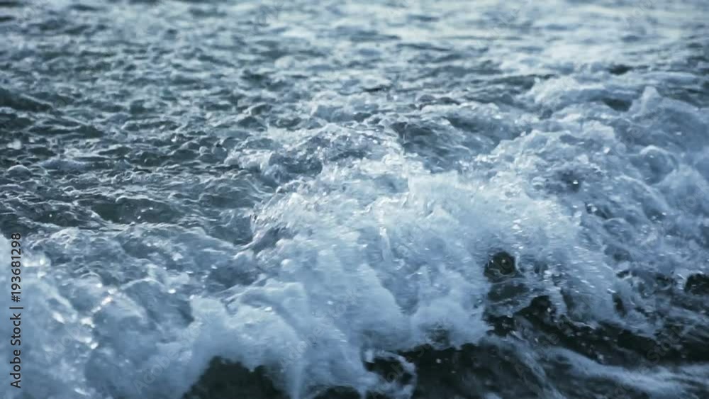 Slow motion detail of waves splashing and moving over the sea Slow motion detail of waves splashing and moving over the sea