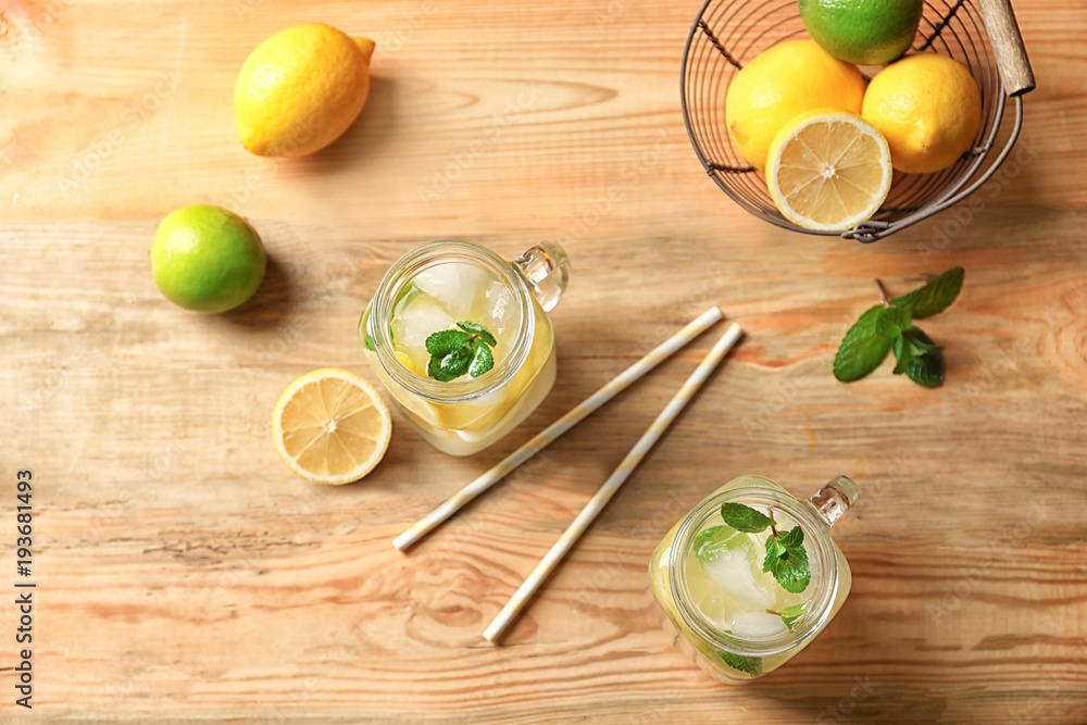 Tasty lemonade with mint in mason jars on table Tasty lemonade with mint in mason jars on table