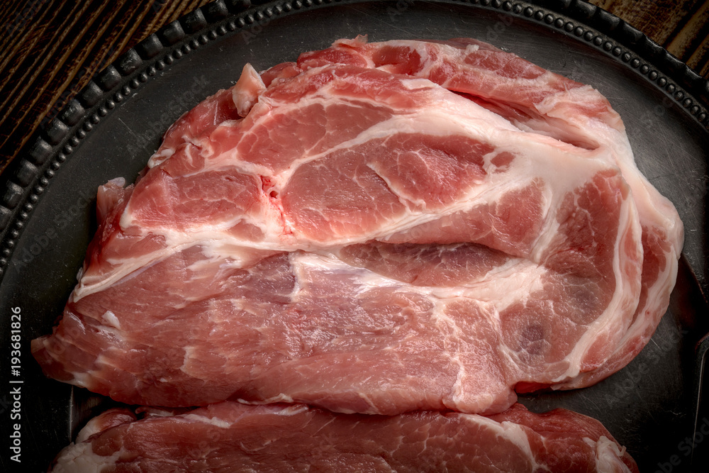 Slices of raw pork neck.