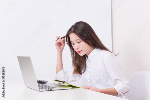 Thoughtful modern business woman documents in office