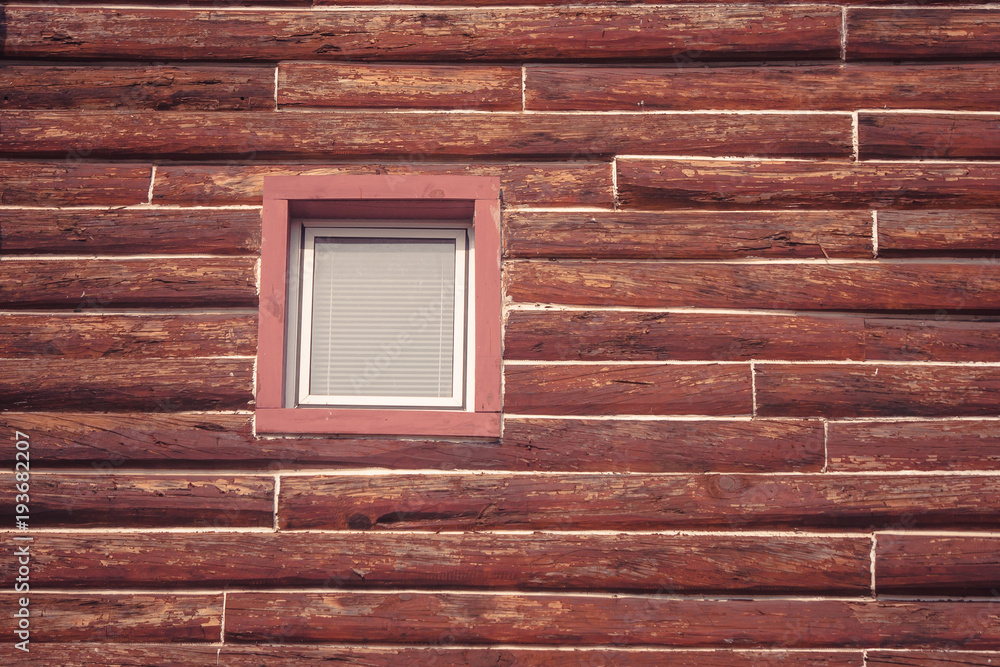 Front view of wooden window on rooftop of wooden house in vintage style at countryside. (Selective focus)