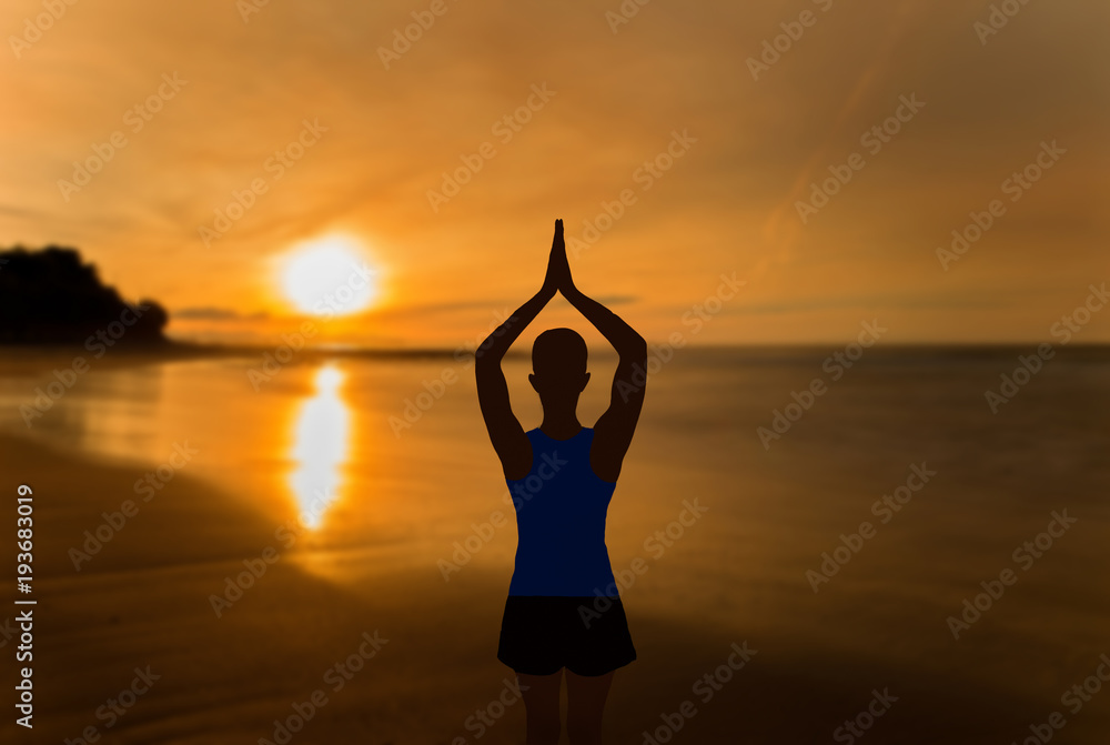 A girl practicing yoga in a sunset