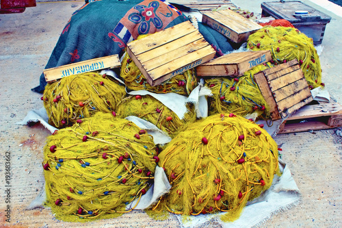 Fishing nets at the harbor of Panormos, a fishing village in Tinos island, Cyclades, Greece. photo