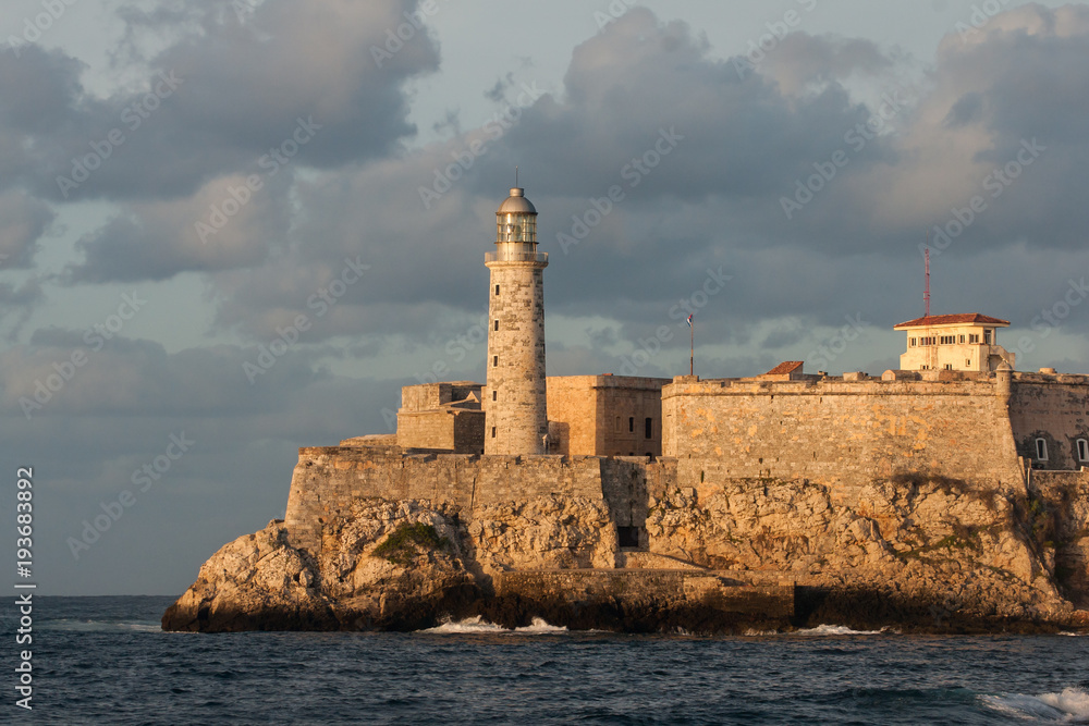 The fortress and the lighthouse of El Morro in the entrance of Havana bay, Cuba. At sunset