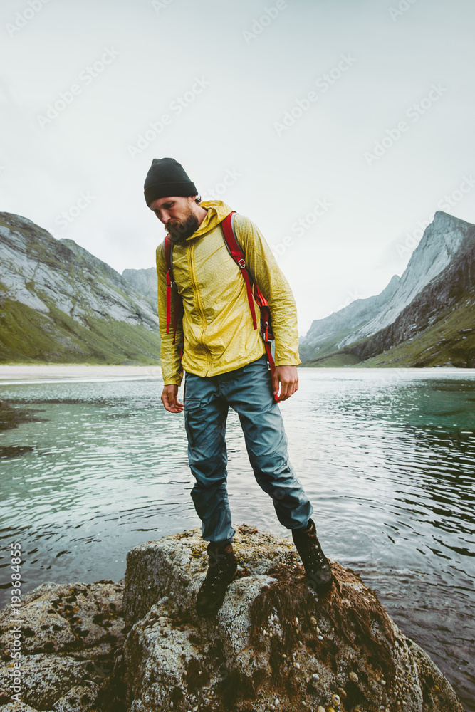 Tourist Man walking alone at sea Travel lifestyle wanderlust concept adventure outdoor summer vacations