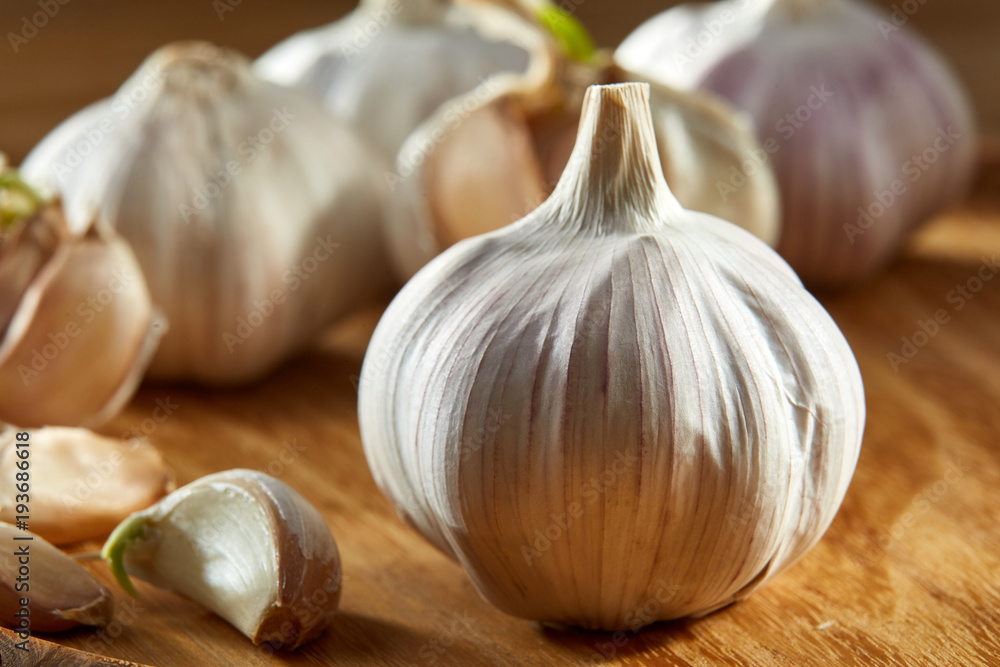 Garlic close up on rustic wooden background, shallow depth of field, selective focus, macro Garlic close up on rustic wooden background, shallow depth of field, selective focus, macro