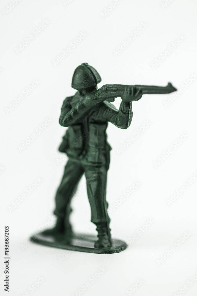 Classic green toy army soldier aiming his gun. Classic green toy army soldier aiming his gun.