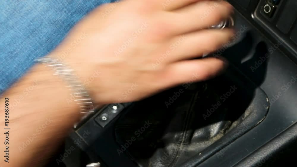 Hand of male car driver shifting gears while driving auto, cheap taxi service Hand of male car driver shifting gears while driving auto, cheap taxi service