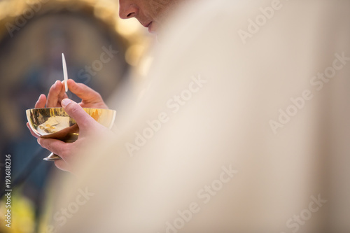 Photography Priest' hands during a wedding ceremony/nuptial mass (shallow DOF; color toned i