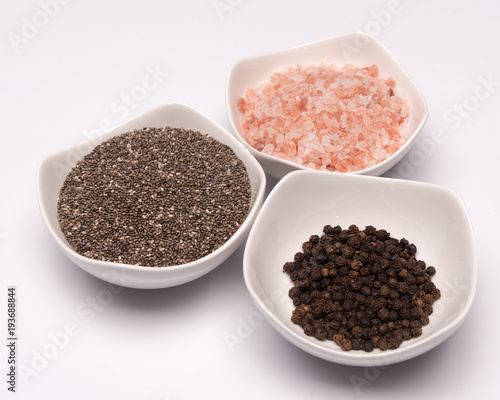 a set of spices in white bowls 