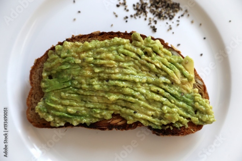 Avocadocreme auf getoastetem Brot auf weißem Teller