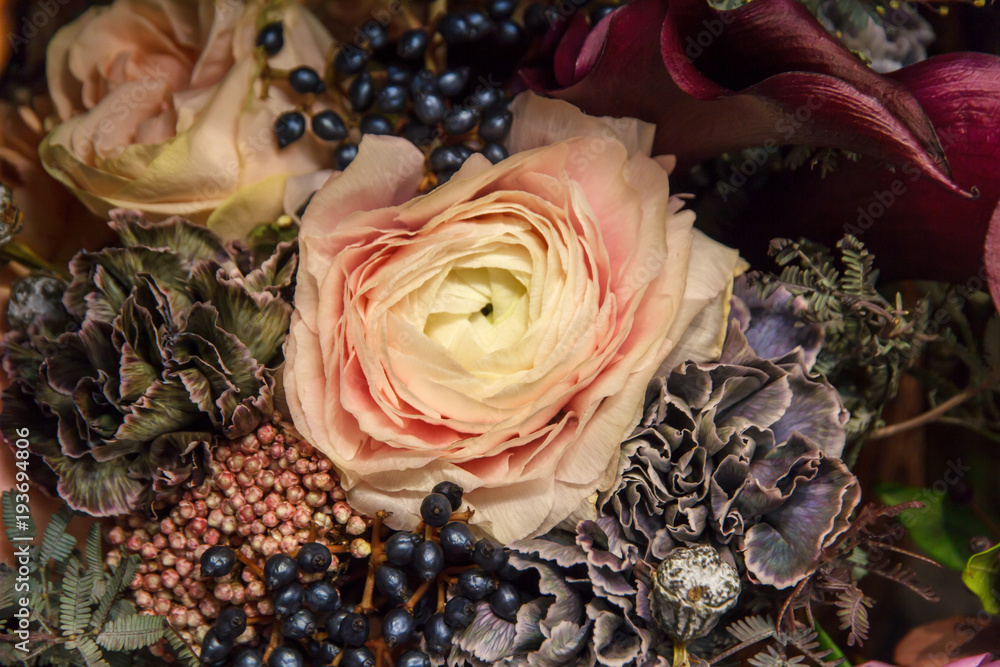 Designer dark wedding bouquet with yellow creme rose of florist closeup. Flowers background