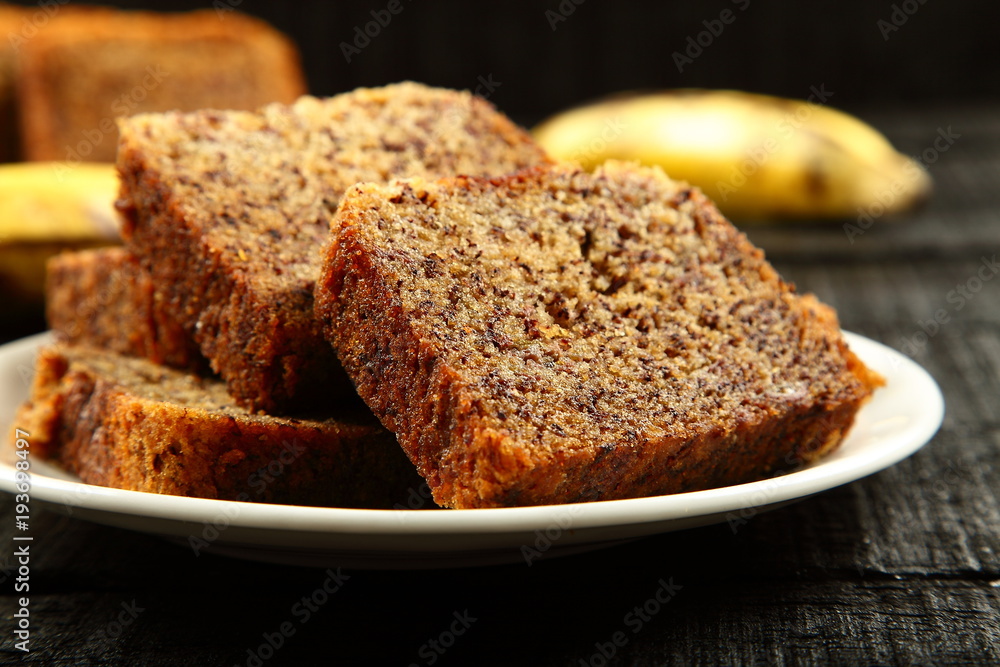 delicious banana cake on a rustic wooden table.