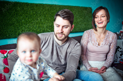 Small daughter with her parents. happy family concept