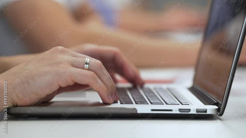 Office worker uses laptop close-up. Office worker uses laptop close-up.