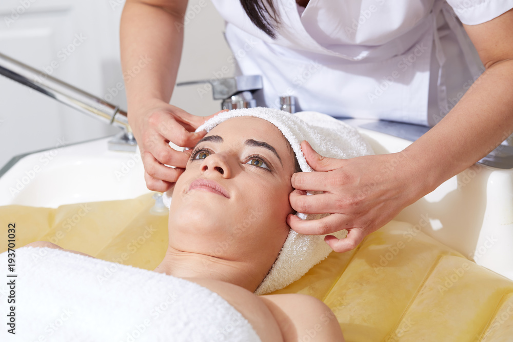 Female Enjoying Relaxing on Massage water bed In Cosmetology Spa Center Female Enjoying Relaxing on Massage water bed In Cosmetology Spa Center