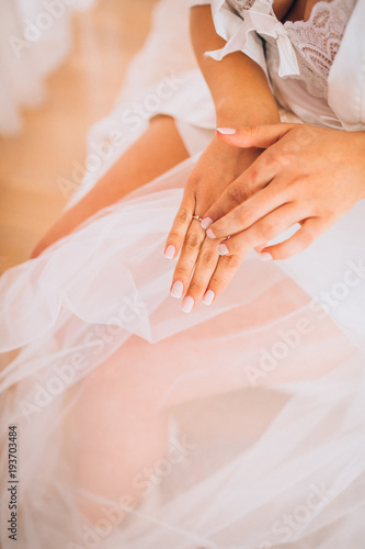 Bridal morning preparation. Wedding ring on bride s hand. Artwork. Selective focus on the wedding ring. Close-up