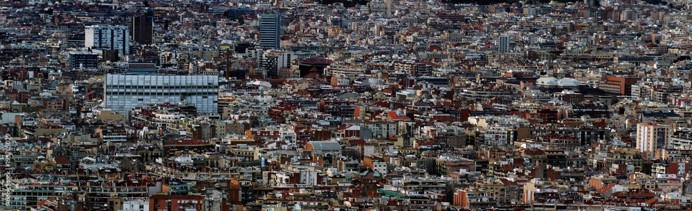 panoramic aerial cityscape view of the barcelona cityscape showing densely crowded buildings towers and streets