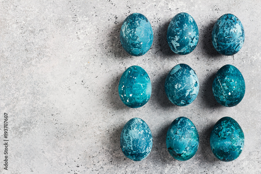 Easter eggs row painted by hand in blue color on light background Easter eggs row painted by hand in blue color on light background