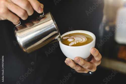 Barista making coffee latte art in coffee shop