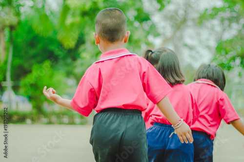 Kindergarten students are exercising in morning.